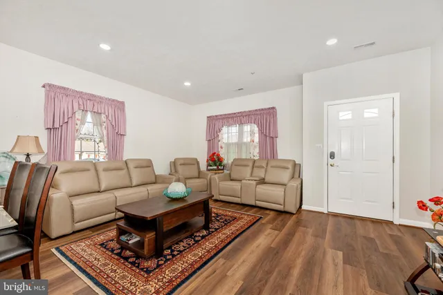 a living room with furniture a rug and a window