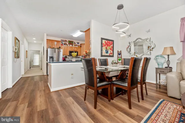 a living room with furniture and a dining table
