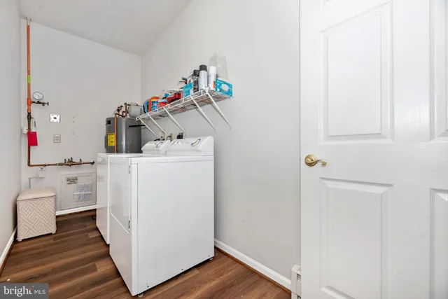 a kitchen with stainless steel appliances granite countertop a refrigerator a stove and a wooden floors