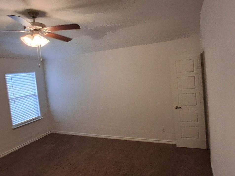 141 Colony Way Fate, TX 75189 - Photo 14 of 20 an empty room with a window and a fan