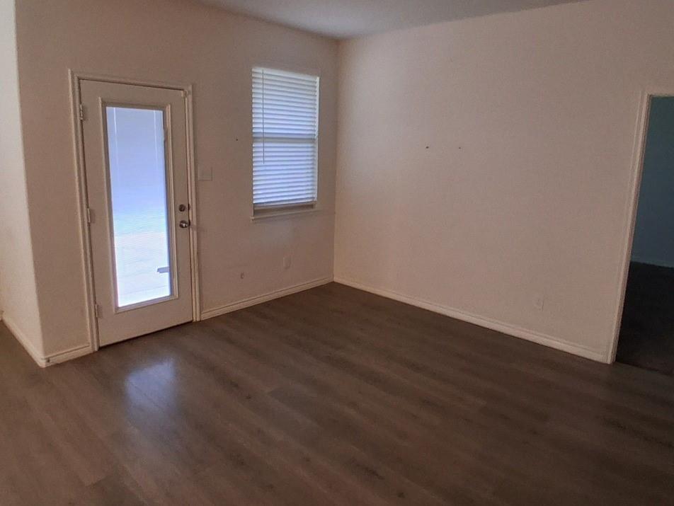 141 Colony Way Fate, TX 75189 - Photo 4 of 20 an empty room with wooden floor and windows