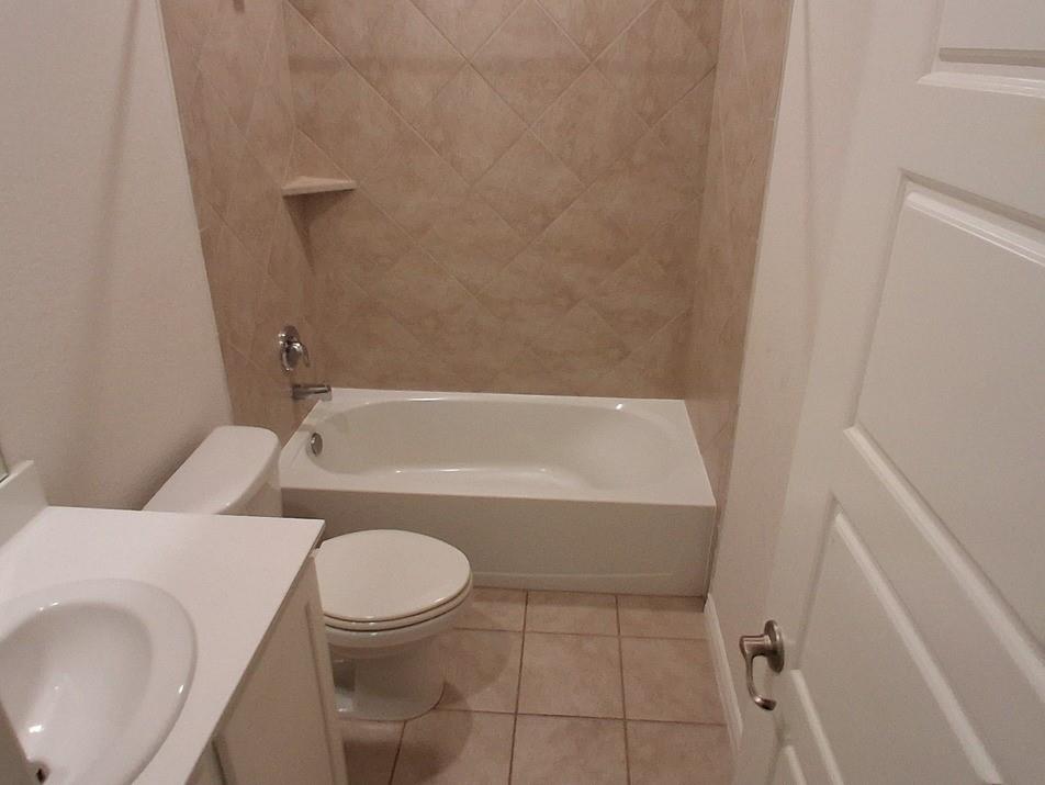 141 Colony Way Fate, TX 75189 - Photo 8 of 20 a bathroom with a toilet and a bathtub