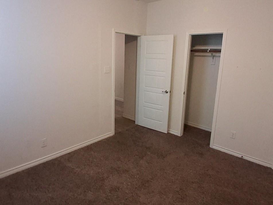 141 Colony Way Fate, TX 75189 - Photo 9 of 20 an empty room with closet and wooden door