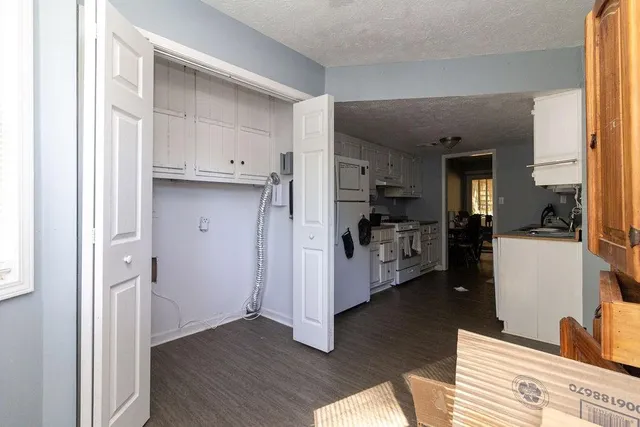 a view of kitchen with refrigerator and wooden floor