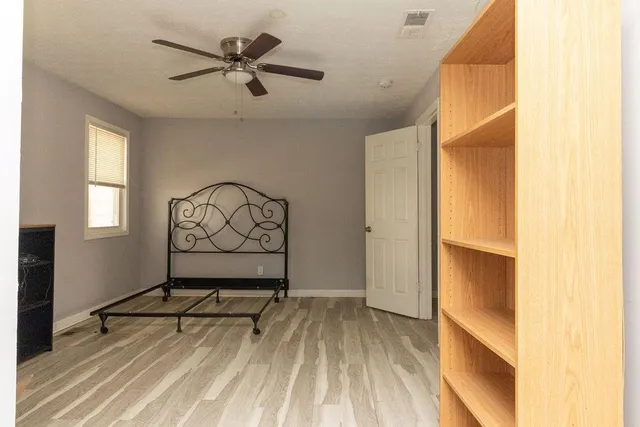 a view of room with window and wooden floor