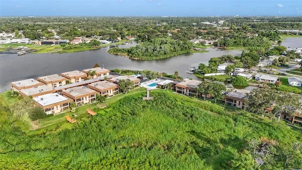 an aerial view of a house with a lake view