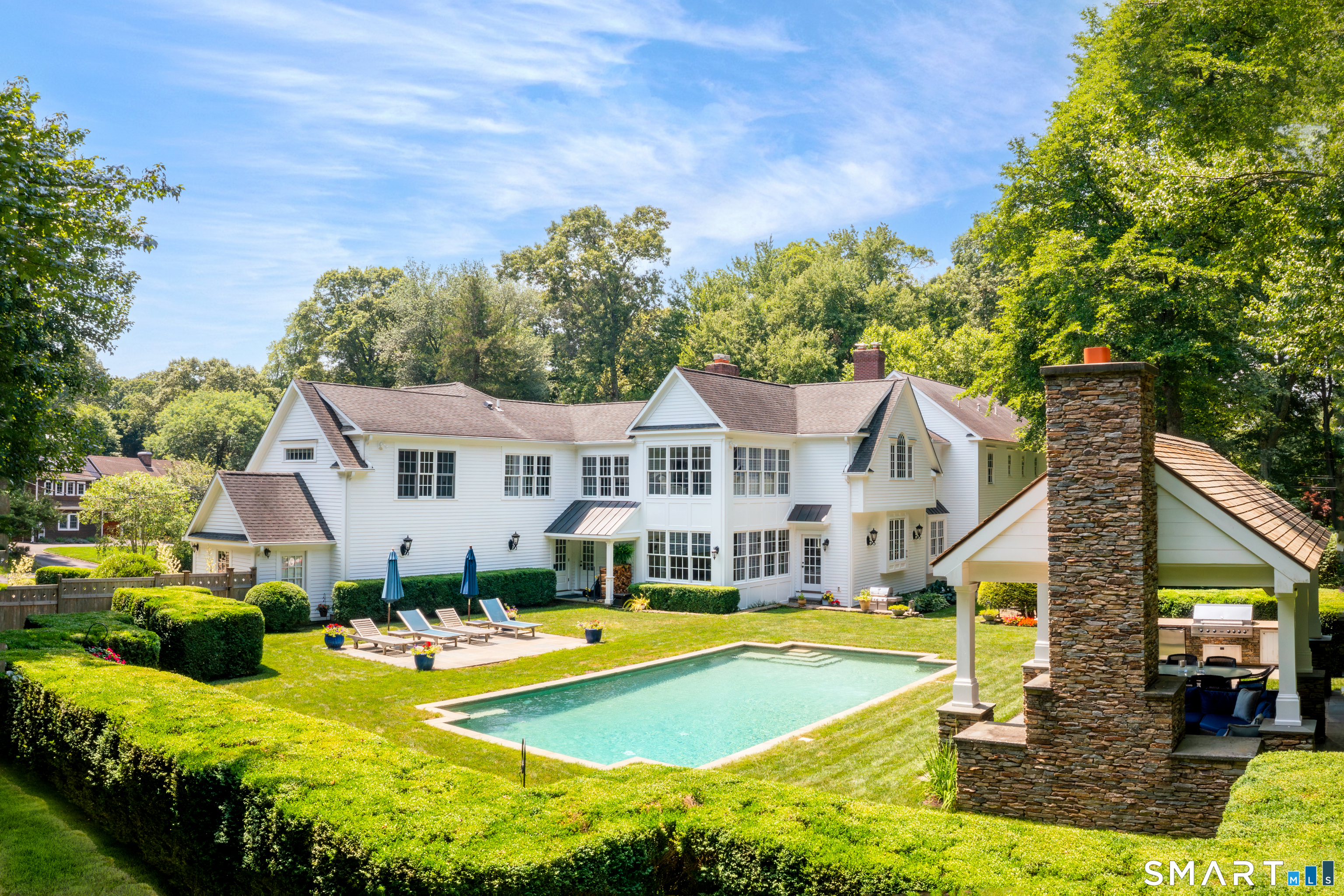 2 High Noon Road Weston, CT 06883 - Photo 3 of 12 Fabulous back yard with gunite pool and outdoor living room w/ grill station, refrigerator and outdoor fieldstone fireplace