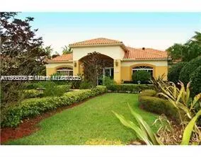 a view of a house with a swimming pool and a yard