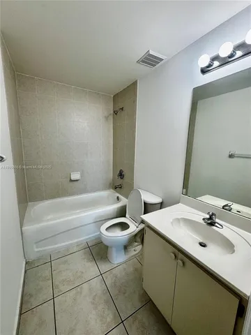 a bathroom with a sink a toilet and bathtub