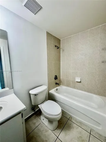 a bathroom with a toilet a sink and shower