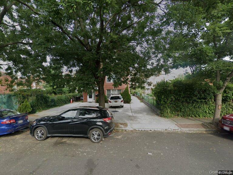 a view of a car parked in back of a house