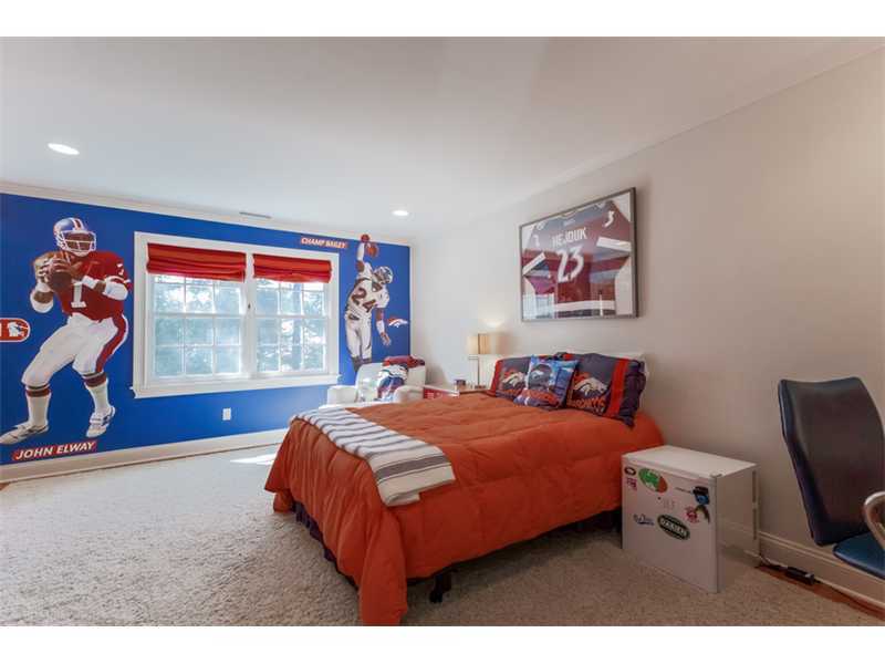 141 Brookside Road Darien, CT 06820 - Photo 13 of 26 a bedroom with a bed and a flat screen tv