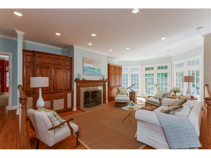 141 Brookside Road Darien, CT 06820 - Photo 25 of 26 a living room with furniture a fireplace and a floor to ceiling window