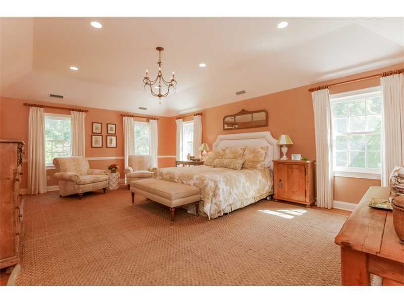 141 Brookside Road Darien, CT 06820 - Photo 10 of 26 a spacious bedroom with a bed and a couch