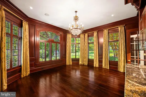 a living room with furniture fireplace and wooden floor