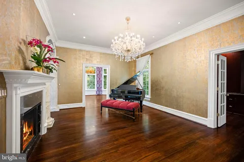 a dining room with furniture a rug and a chandelier