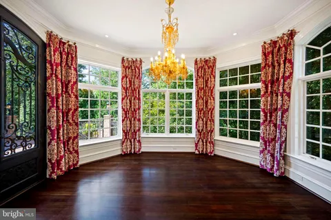 a large white kitchen with a large window