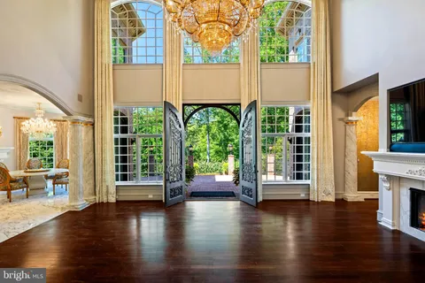 a bedroom with bed and a large window