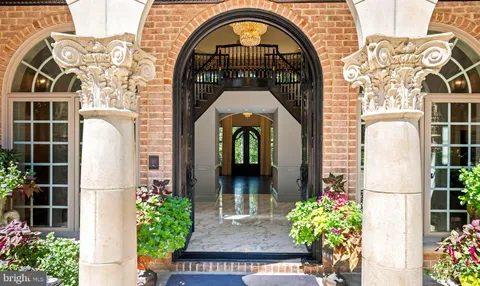a living room with fireplace furniture and a large window