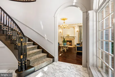 a view of a livingroom with furniture wooden floor and a chandelier