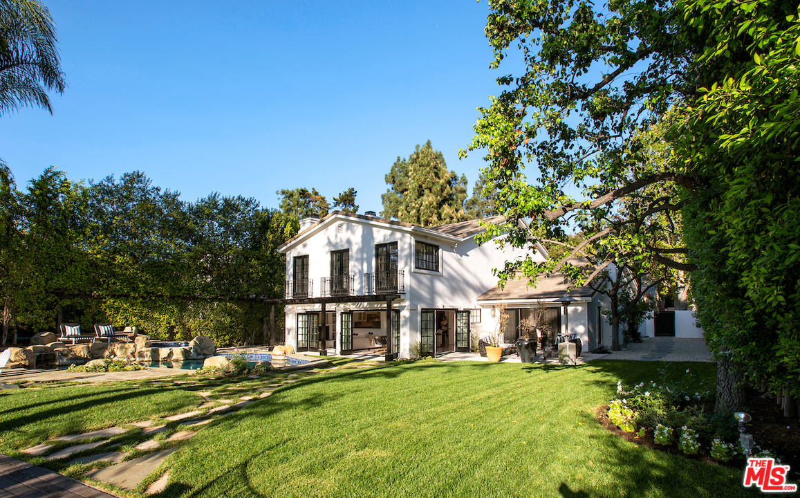 a front view of a house with a yard table and chairs