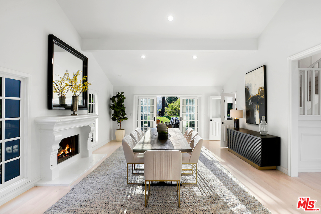 9653 Wendover Drive Beverly Hills, CA 90210 - Photo 14 of 34 a dining room with furniture a fireplace and wooden floor