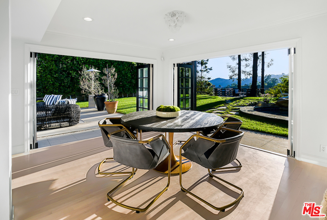 9653 Wendover Drive Beverly Hills, CA 90210 - Photo 3 of 34 a view of a dining room with furniture wooden floor and garden view