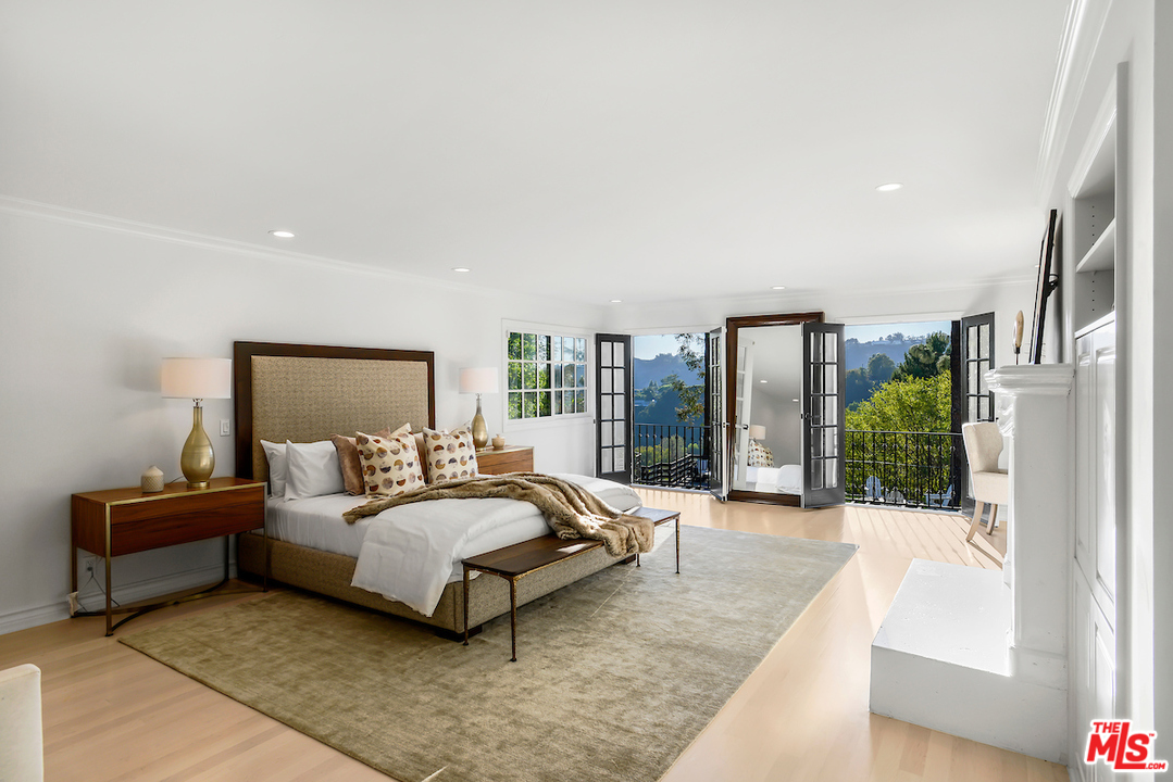 9653 Wendover Drive Beverly Hills, CA 90210 - Photo 25 of 34 a bed room with a bed and a couch