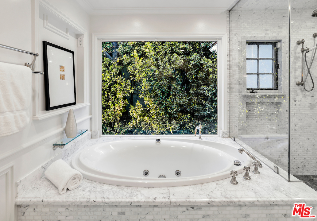 9653 Wendover Drive Beverly Hills, CA 90210 - Photo 29 of 34 a bath tub sitting in a bathroom next to a window