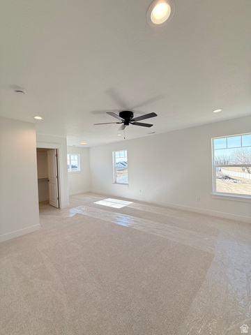 1142 West 220 North Mapleton, UT 84664 - Photo 12 of 26 Spare room with light carpet, recessed lighting, healthy amount of natural light, and a ceiling fan