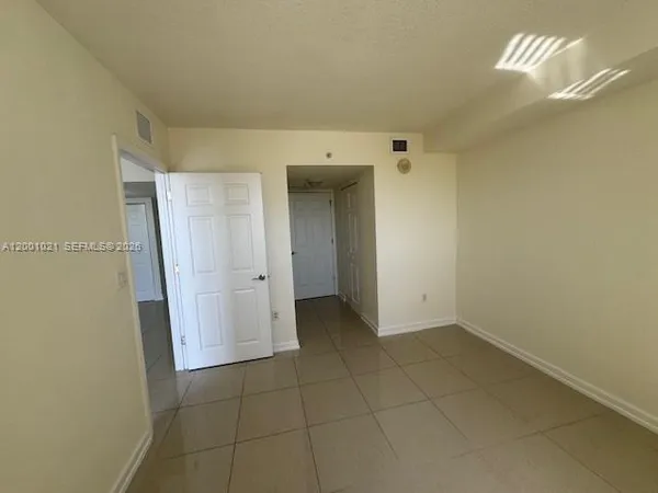 a view of an empty room with a bathroom