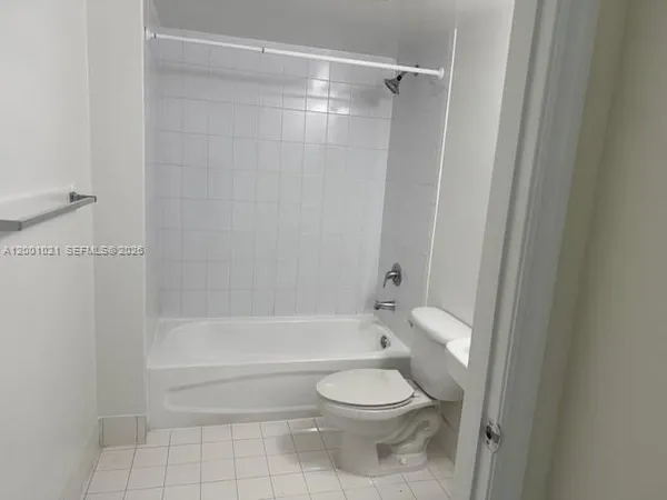 a bathroom with a toilet and a bath tub