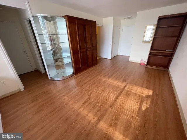 a balcony with table and chairs potted plants