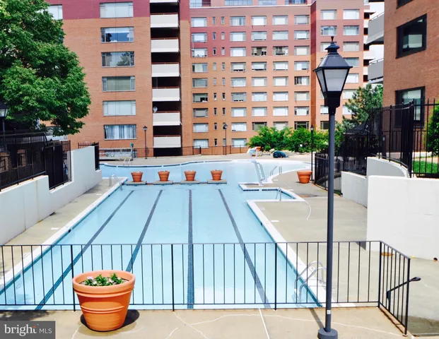 a view of an empty room with wooden floor and stairs
