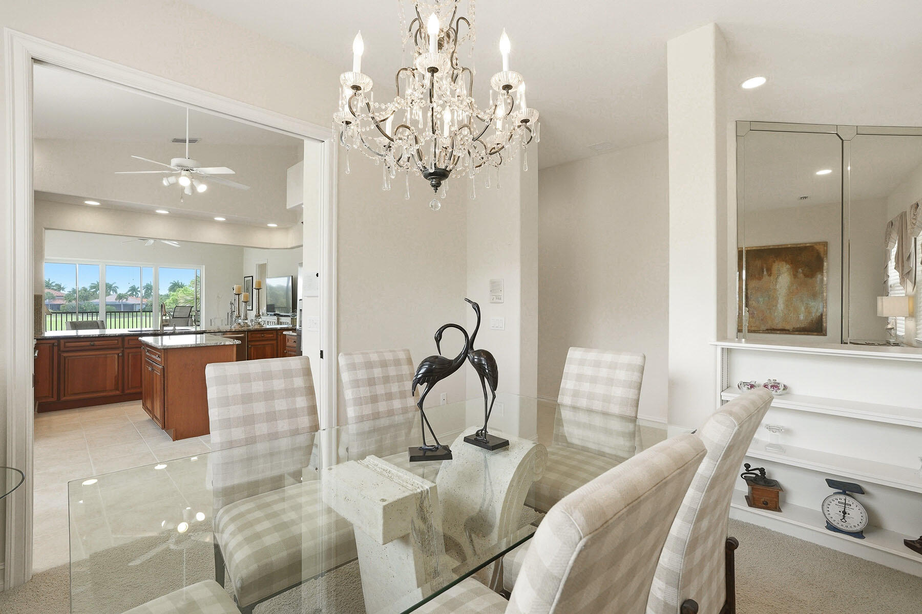 8605 Champions Point, Unit 103 Naples, FL 34113 - Photo 6 of 44 a dining room with furniture a chandelier and window