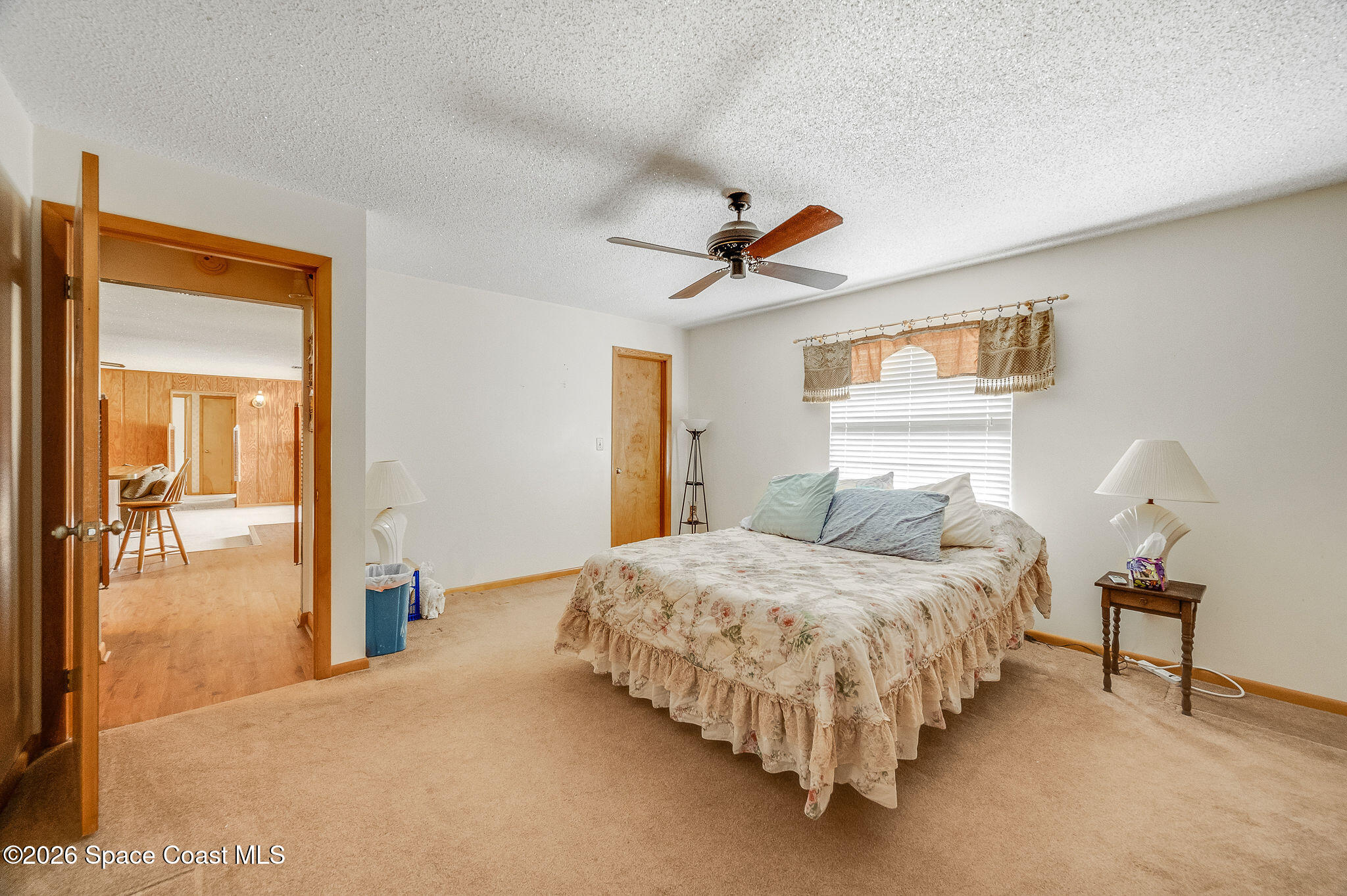 4600 Janet Road Cocoa, FL 32926 - Photo 20 of 50 a bedroom with a bed and a chandelier