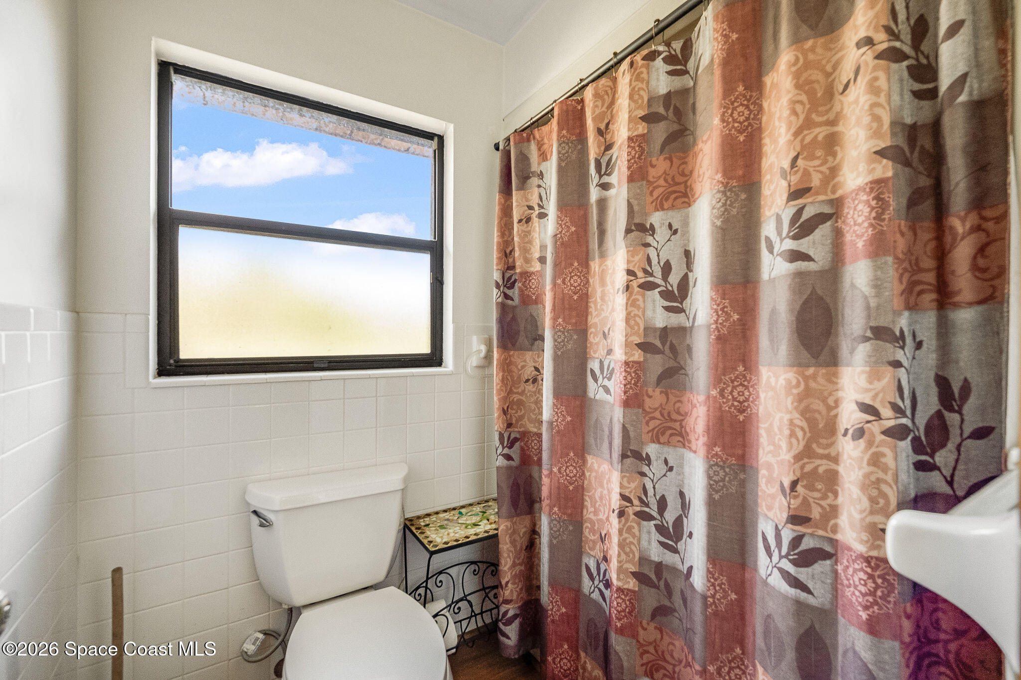 4600 Janet Road Cocoa, FL 32926 - Photo 24 of 50 a bathroom with a toilet and a shower curtain