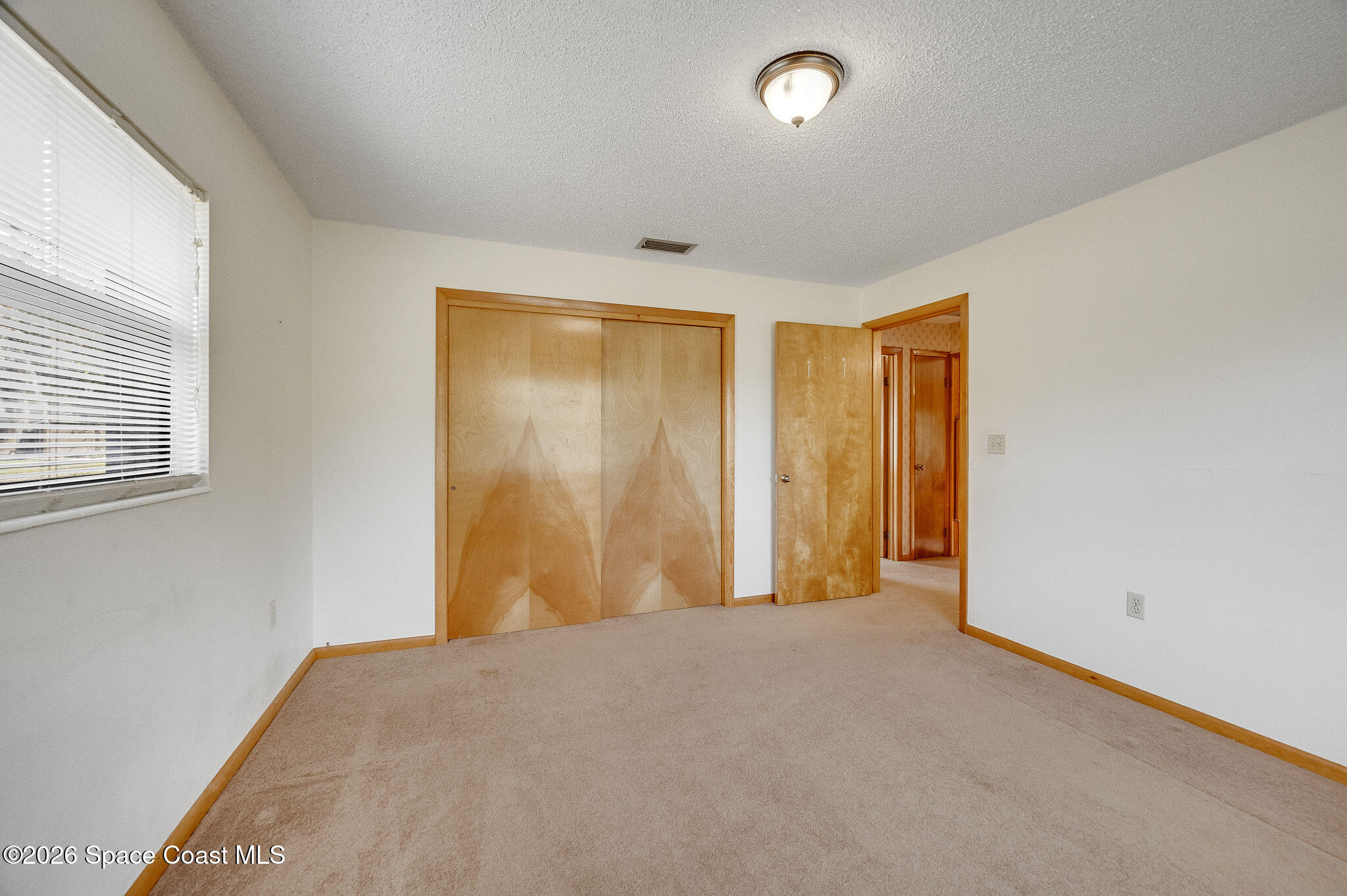 4600 Janet Road Cocoa, FL 32926 - Photo 26 of 50 a view of a room with a wooden floor and a window