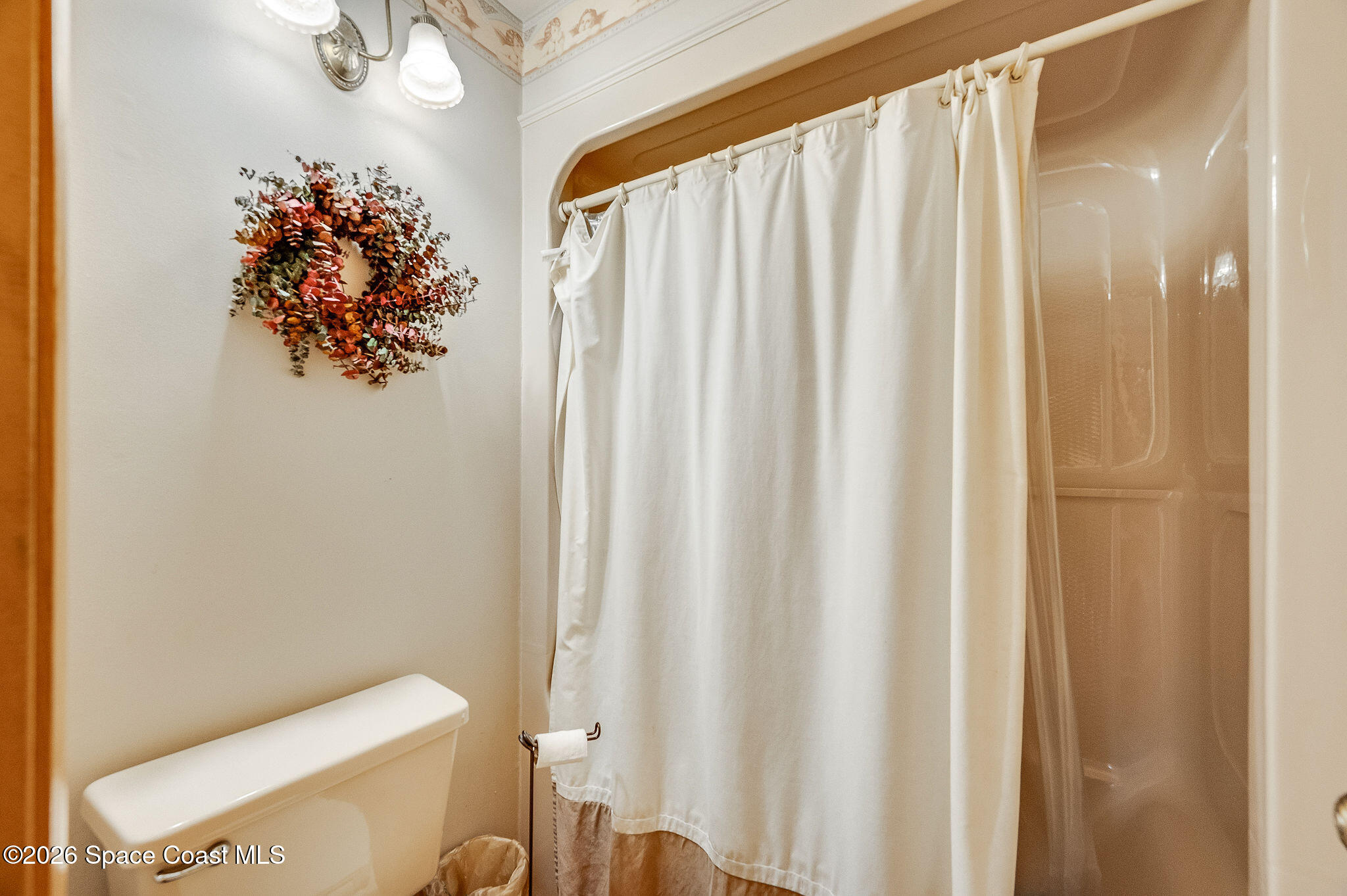 4600 Janet Road Cocoa, FL 32926 - Photo 30 of 50 a bathroom with a toilet and a shower curtain