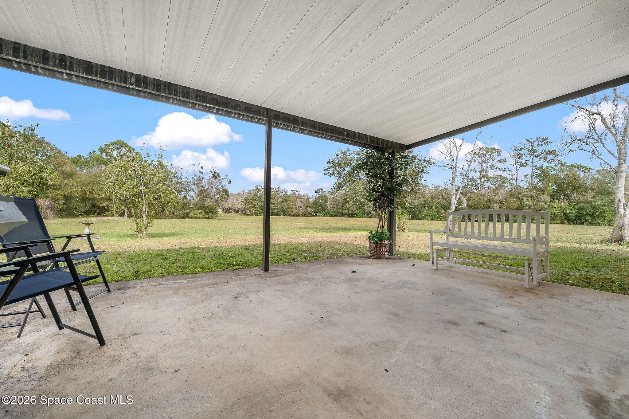 4600 Janet Road Cocoa, FL 32926 - Photo 31 of 50 a view of a yard with porch and wooden fence