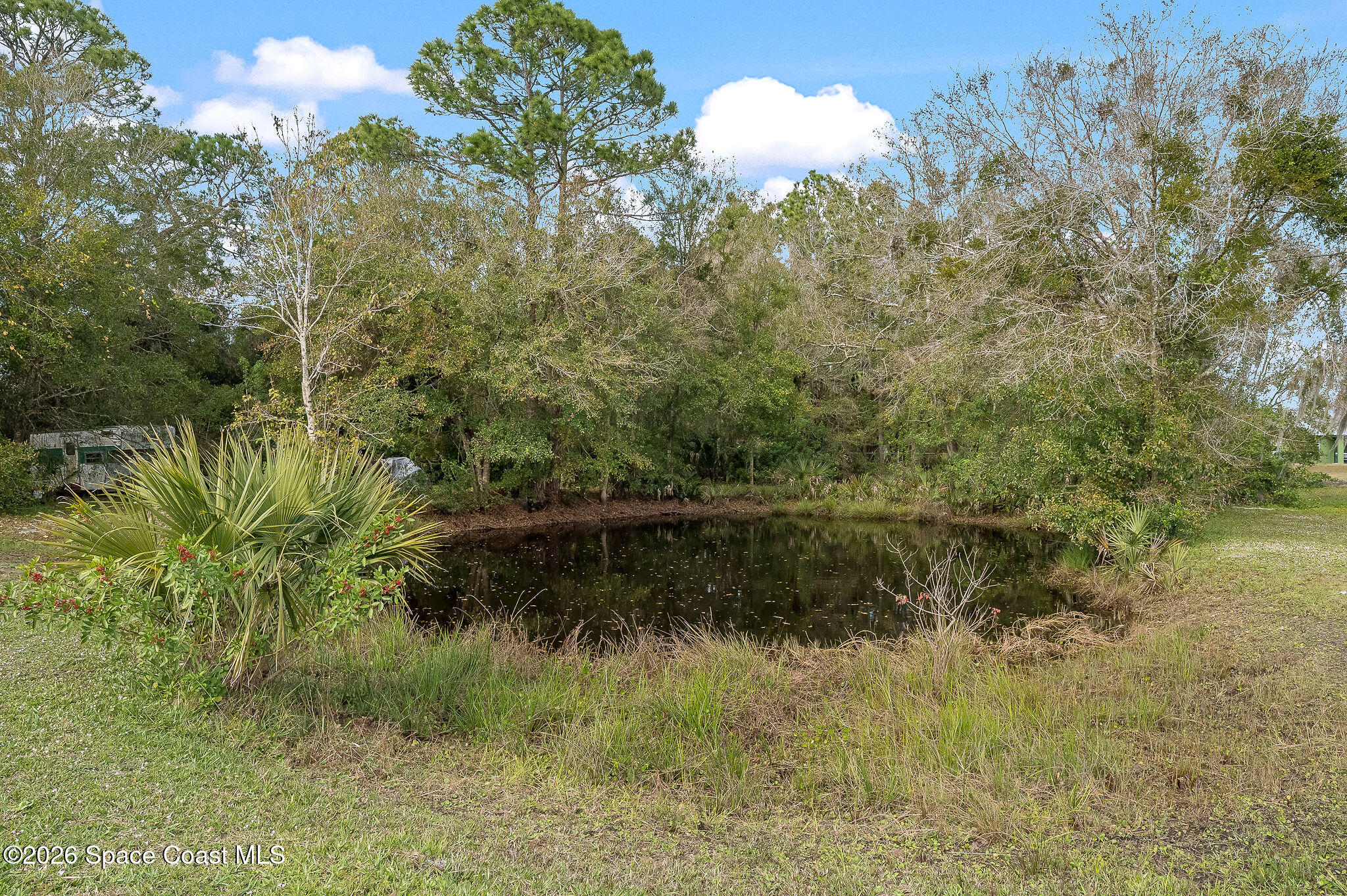 4600 Janet Road Cocoa, FL 32926 - Photo 48 of 50 a view of a lake with a yard