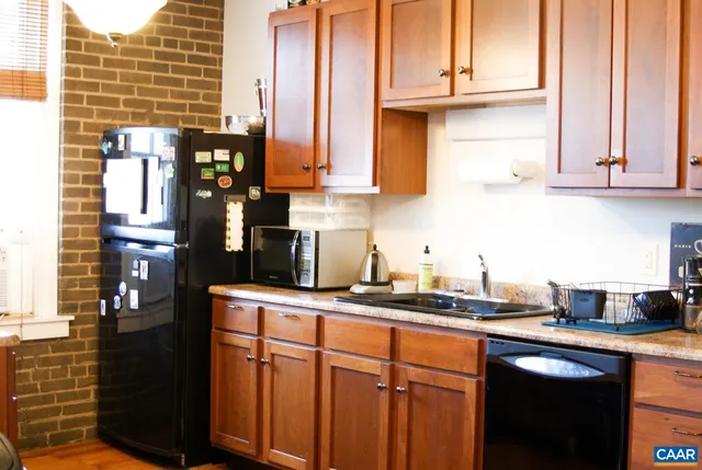 a kitchen with stainless steel appliances granite countertop a sink and cabinets
