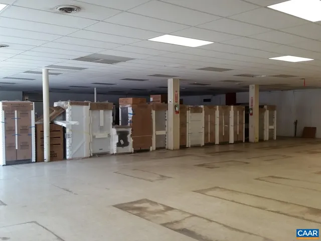 a view of a hall with wooden floors