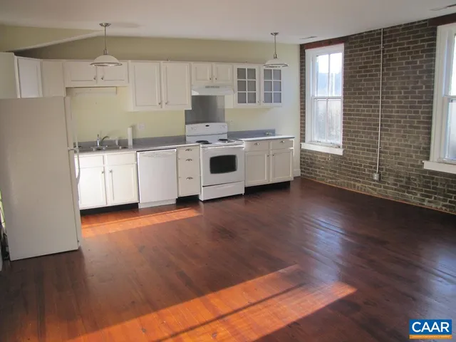 a kitchen with stainless steel appliances a white cabinets and sink