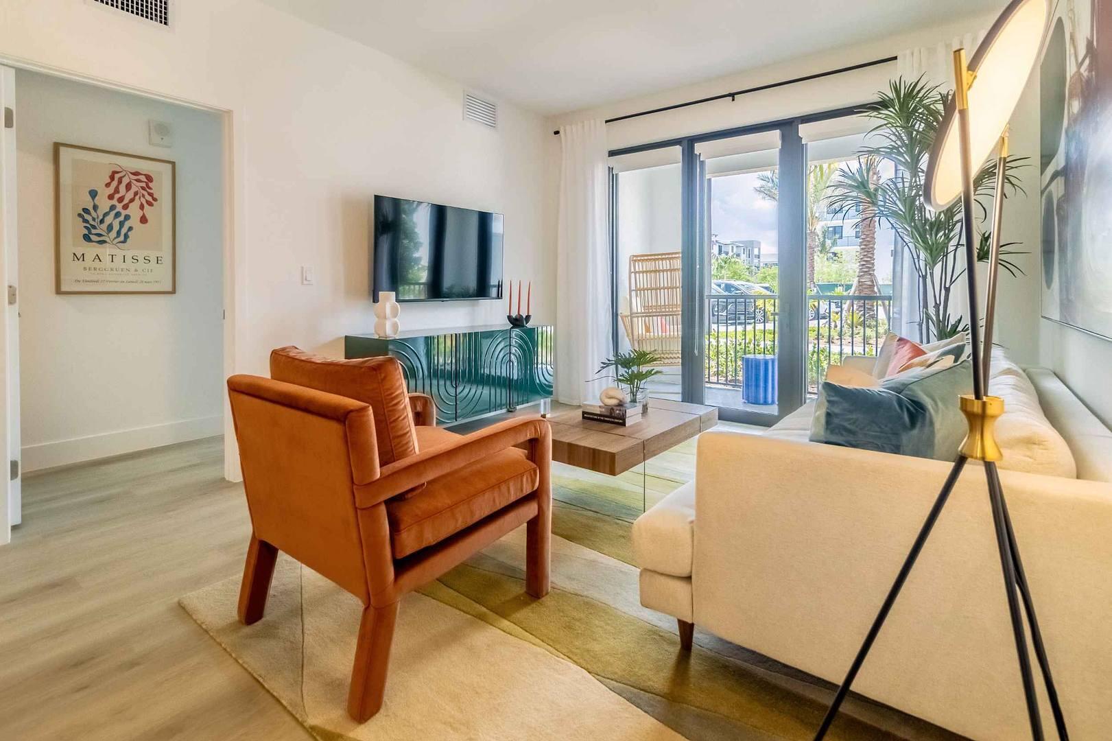 12245 Southwest 30th Street, Unit 112 Miramar, FL 33025 - Photo 3 of 16 a living room with a couch and a flat screen tv