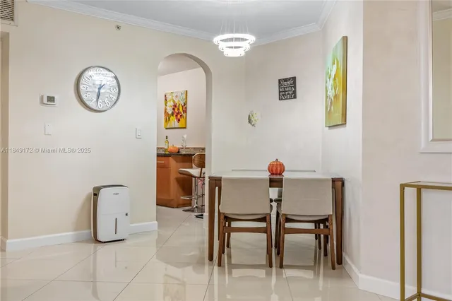 a dining hall with granite countertop a sink and a mirror