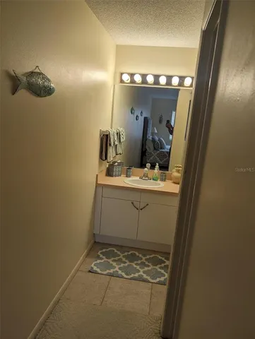 a bathroom with a sink and mirror