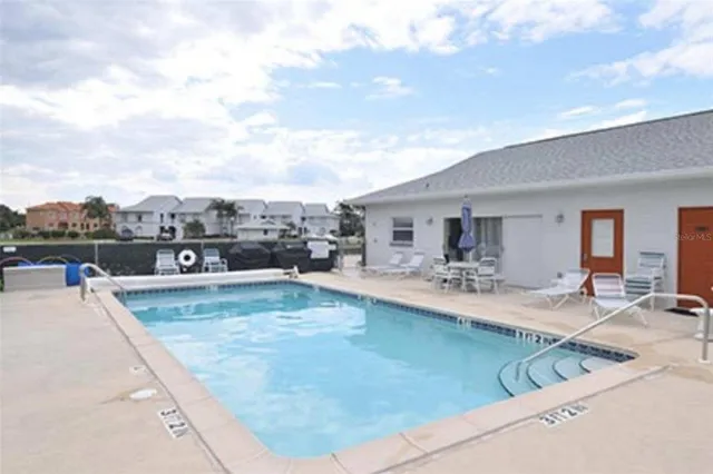 a view of a patio with swimming pool table and chairs