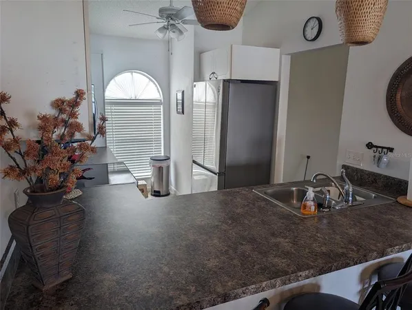 a kitchen with a refrigerator and a sink