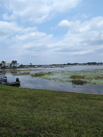 a view of a lake with houses in the back